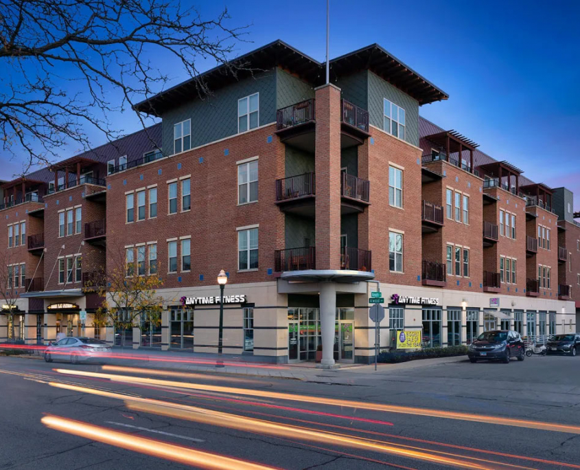 Apartment at sunset with shops below and apartments above