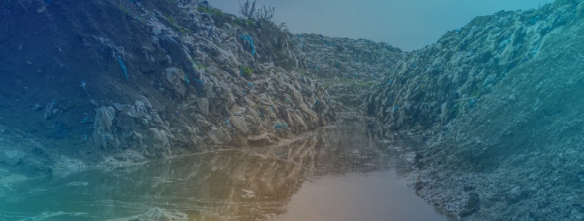 Garbage dump with small creek running through it